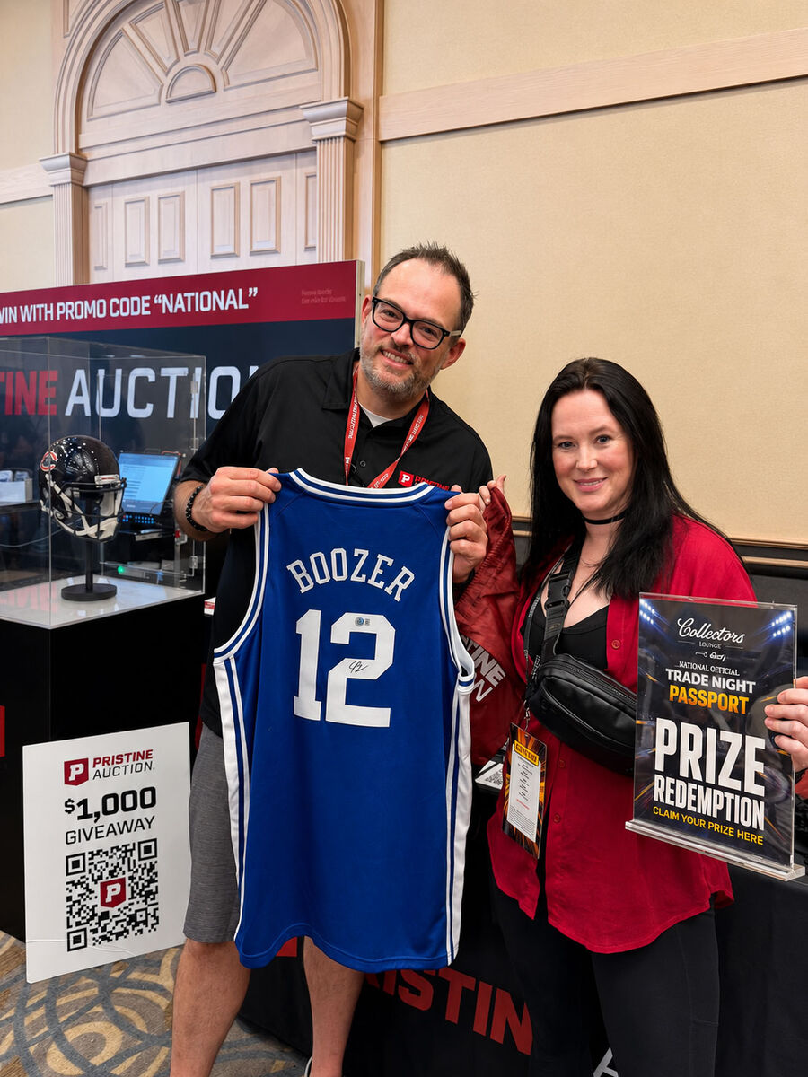 A winner collecting a signed jersey at the prize redemption booth